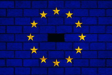 The European Union with Euro symbol points economic crisis. European Union Flag on brick wall. Flag incomplete or partially destroyed.