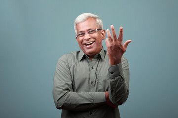 Elderly man of Indian ethnicity with a laughing expression