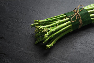 Asparagus from the garden on black stone background
