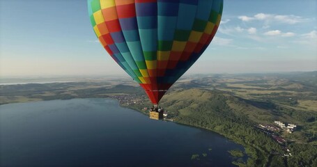 Colorful hot air balloon epic flying above mountain over the fog at sunrise with beautiful sky background - High altitude aerial drone wide view
