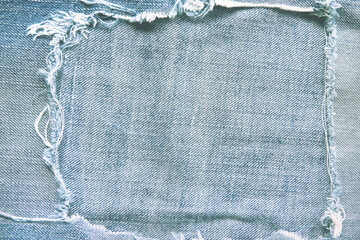 Blue denim frame light texture with torn patterns abstract for background and space