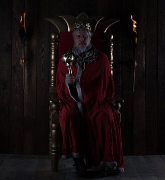 Ancient King On The Throne On A Dark Background