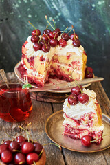 Cherry cake. Yeast bun with cherries and cream. A piece of cake. Top view, wooden and blue background.