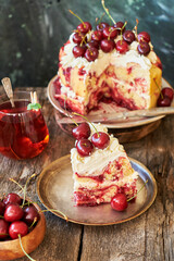 Cherry cake. Yeast bun with cherries and cream. A piece of cake. Top view, wooden and blue background.