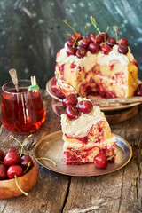 Cherry cake. Yeast bun with cherries and cream. A piece of cake. Top view, wooden and blue background.