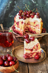 Cherry cake. Yeast bun with cherries and cream. A piece of cake. Top view, wooden and blue background.
