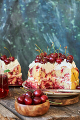 Cherry cake. Yeast bun with cherries and cream. A piece of cake. Top view, wooden and blue background.