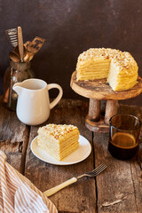 Cake on a wooden cake stand. Shortcrust pastry cake, decorated with shortcrust crumbs. Wooden background, rustic, side view. 