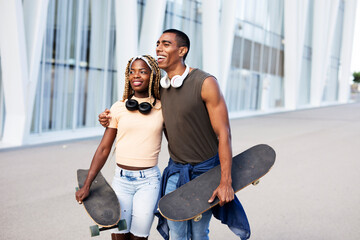 Obraz premium Beautiful couple having fun outdoors. Portrait of an excited young couple with skateboard.