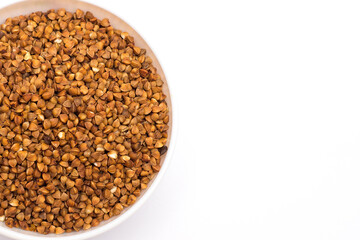 Pile of buckwheat isolated on white background. Top view. Buckwheat. Buckwheat grains. Grain culture.