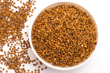 Pile of buckwheat isolated on white background. Top view. Buckwheat. Buckwheat grains. Grain culture.