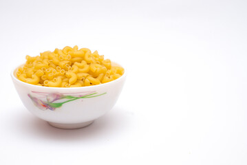 Raw italian pasta in bowl isolated on white