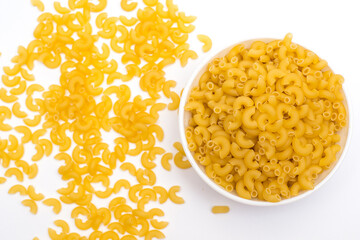 Raw italian pasta in bowl isolated on white