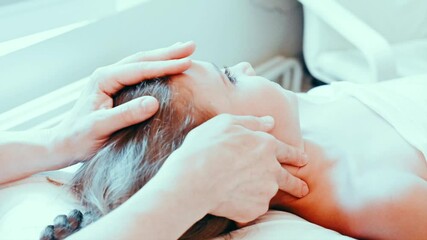 real doctor osteopath hands does physiological and emotional therapy for eight year old kid girl. pediatric osteopathy treatment session. alternative medicine. taking care of the child's health