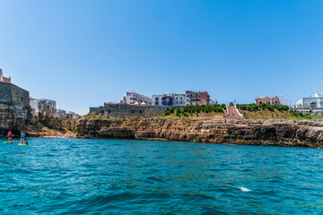Naklejka premium Polignano a Mare seen from the sea. Cliffs and caves
