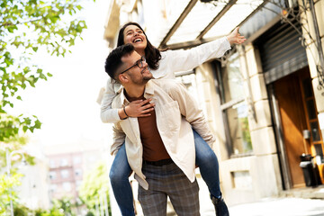 Happy young couple outdoors. Loving couple having fun together.