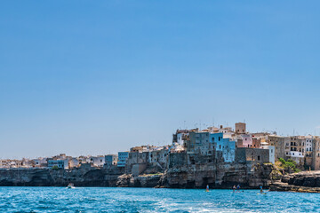Fototapeta na wymiar Polignano a Mare seen from the sea. Cliffs and caves