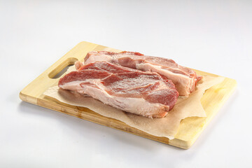 Raw pork fillet over board