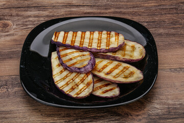 Grilled graffiti eggpant slices with oil
