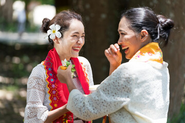 Burmese women are laughing and having fun. Southeast Asian young girls with burmese traditional...