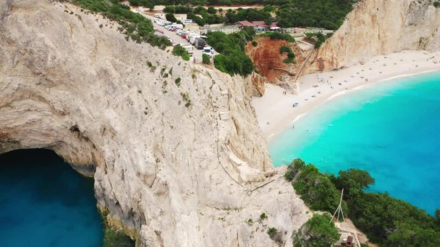 Top down drone raising shot of broken bridge at Porto Katsiki coast at Lefkada island, Greek famous beaches.
