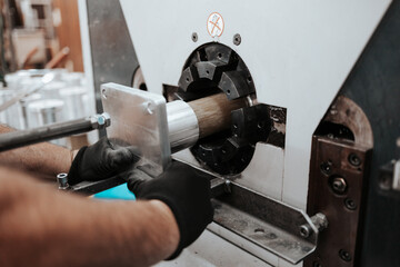 Close up shot of manual worker hands. Factory for industrial production of electric housings and surge arresters.