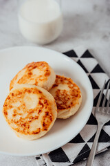 Cottage cheese cheesecakes on a wooden board