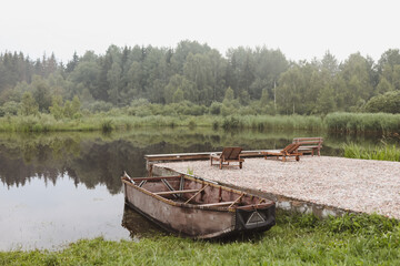 wooden boat by the pier on the lake