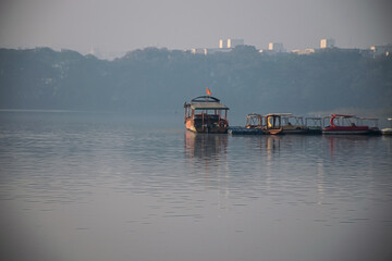 Stock photo of popular Rankala lake boating spot, different types of boat parked by the lake. Picture captured during early morning at Kolhapur city Maharashtra India.