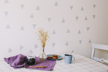 Breakfast with cup of tea and cookies on the table