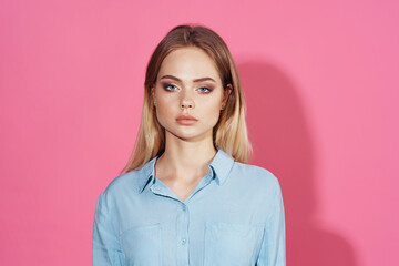 pretty blonde in blue shirt cosmetics pink background