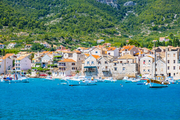 Seafront view at coastal town Komiza on Island Vis, summer travel resort in Croatia, Mediterranean.