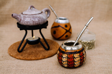 Yerba mate-South American tea, dried leaves in wooden bowl with a wooden mate calabash with tea