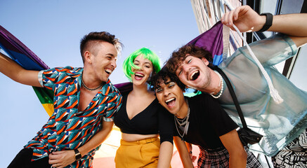 Four young people celebrating their queer identities together - obrazy, fototapety, plakaty
