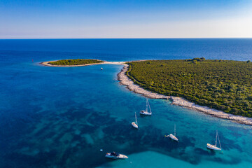 Fototapeta premium Aerial view of sailing boats in a beautiful azure turquoise lagoon on Sakarun beach bay on Dugi Otok island, Croatia, beautiful seascape