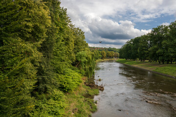 Polish-Czech border on the Olza river in Cieszyn on a summer day with beautiful clouds in the background