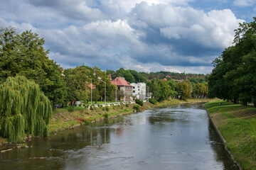 Fototapeta na wymiar Polish-Czech border on the Olza river in Cieszyn on a summer day with beautiful clouds in the background