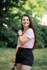 Fototapeta premium beautiful girl walks in the park. summer walks. portrait