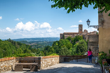 Fototapeta na wymiar Colle di Val d'Elsa, Tuscany, Italy. August 2020. Amazing city landscape along the outer walls of the historic center. Blue sky with white clouds.