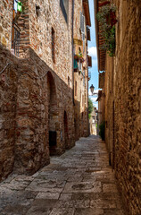 Fototapeta na wymiar Colle dColle di Val d'Elsa, Tuscany, Italy. August 2020. Photo in an alley in the historic center: enchanting glimpses of medieval times full of charm.