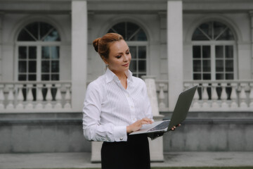 Successful businessman working at laptop. City businesswoman working.