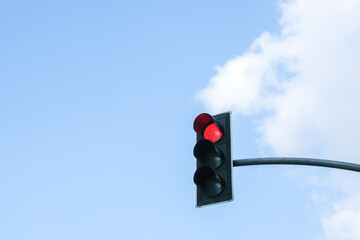 traffic light in front of cloudy sky background