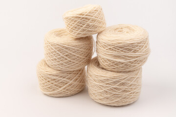 balls of light woolen thread on white background. natural wool. knitting. background