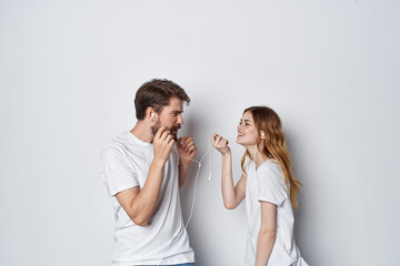 man and woman in white t-shirts are standing next to friendship fun light background