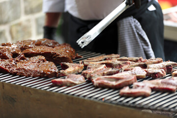 Meat being grilled on a barbecue in a Belgian restaurant. - 449172766