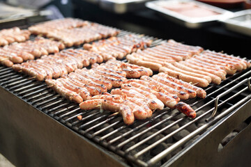 Grill with Belgian sausages cooking on the grill. - 449172903
