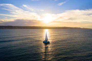 Wandaufkleber Catamaran sailing at sunset © Zstock