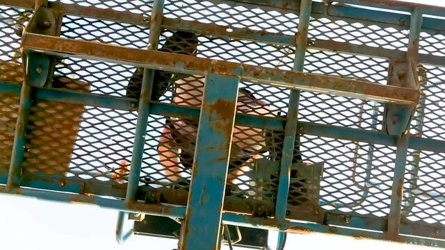 View From Underneath Of Worker On Cherry Picker