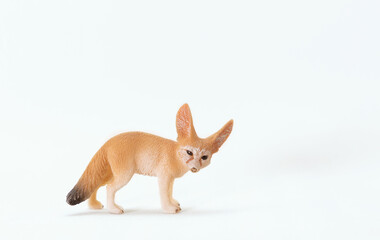 Plastic toy fox isolated on a white background. Cute little animal toy for kids. Copy space