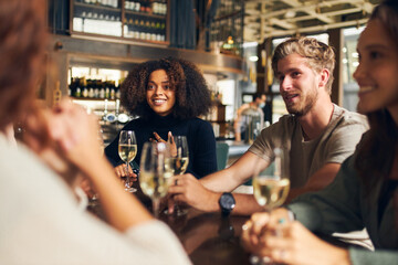 Friends relaxing with wine in bar